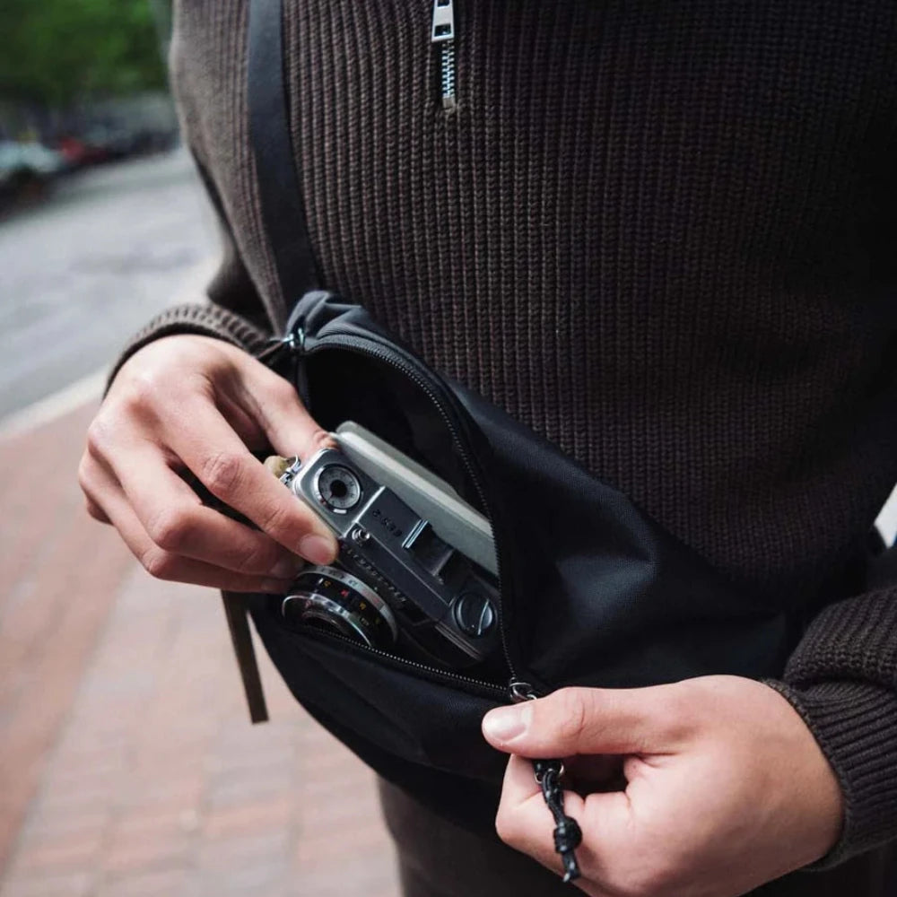 Herschel Kaine Hip Pack Black Lifestyle Opened Bag With Camera Inside