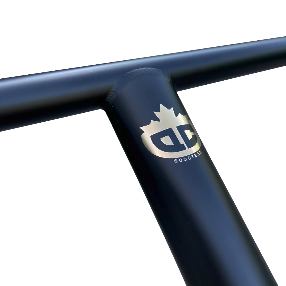 QC Scooters Titanium T-Bars Matte Black Front Laser Etched Gold Logo Close Up